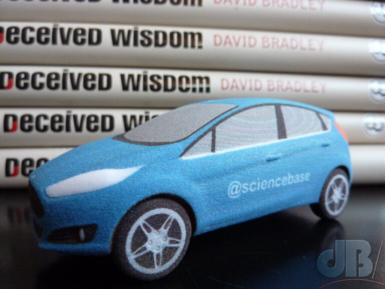 3D-printed model car and stack of books