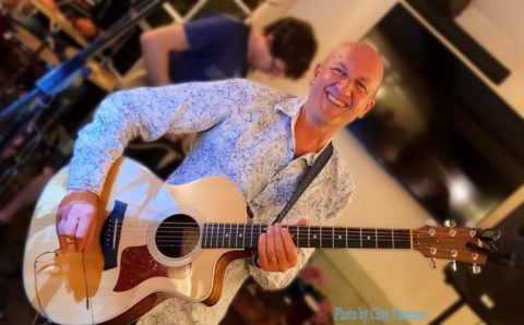 Dave Bradley with a guitar in between songs at a pub gig with his band C5